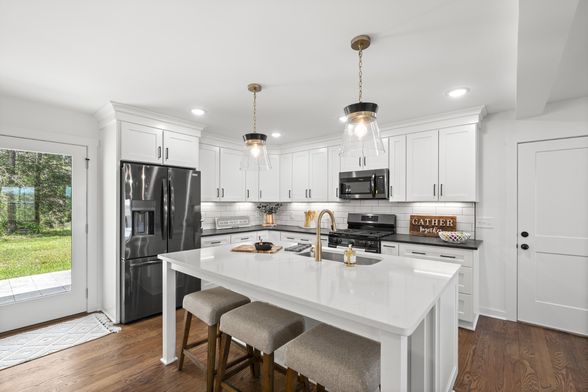 2210 Garners Creek Road Dickson, TN 37055 - Photo 13 of 67 a kitchen with stainless steel appliances a microwave a stove a refrigerator a sink and a table with chairs
