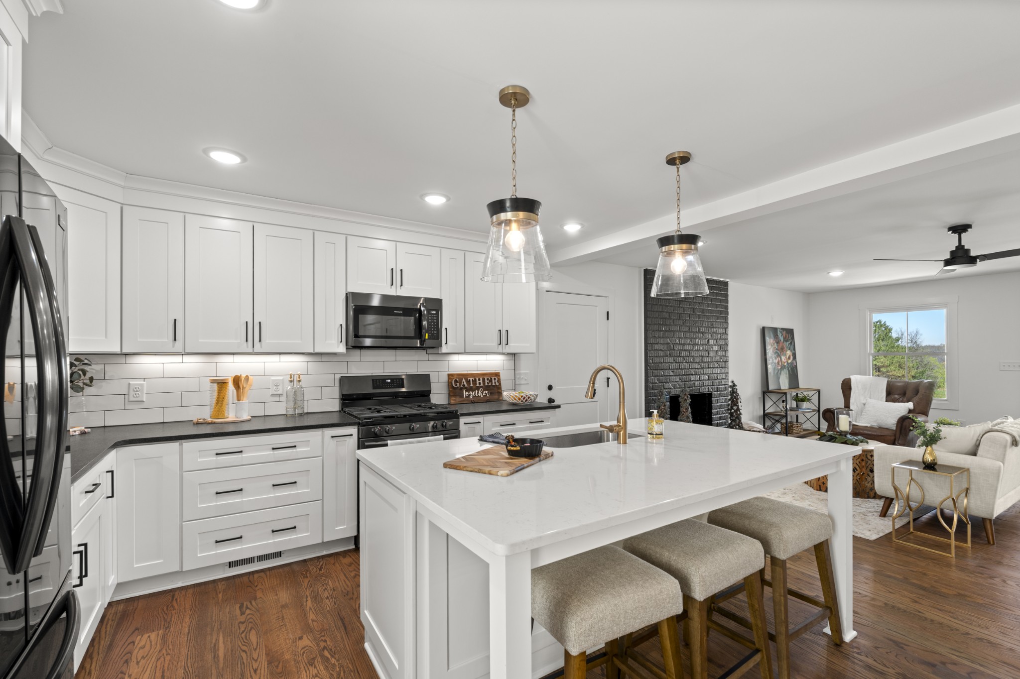 2210 Garners Creek Road Dickson, TN 37055 - Photo 14 of 67 a kitchen with stainless steel appliances kitchen island granite countertop a sink a stove a refrigerator and white cabinets with wooden floor