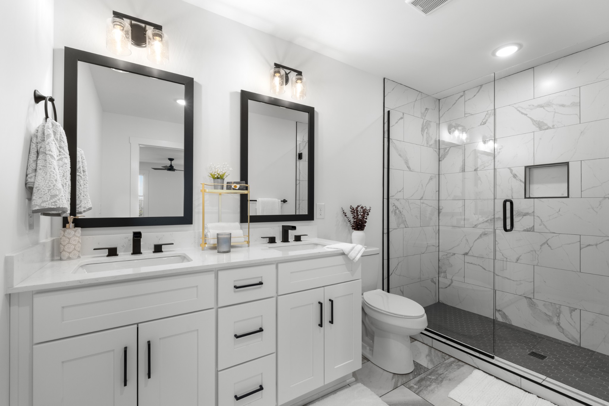 2210 Garners Creek Road Dickson, TN 37055 - Photo 23 of 67 a bathroom with a double vanity sink toilet mirror and shower