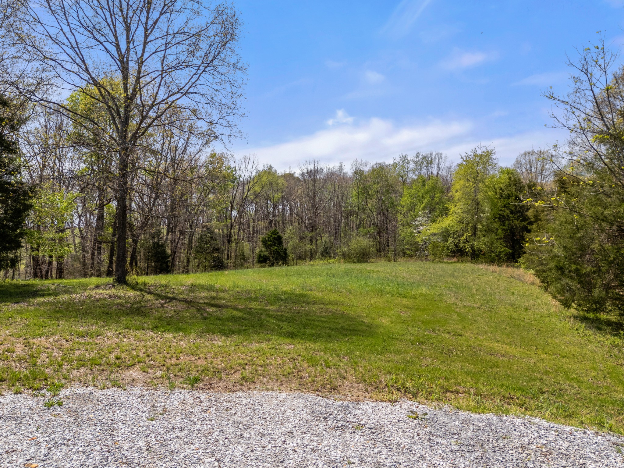 2210 Garners Creek Road Dickson, TN 37055 - Photo 57 of 67 a view of a field with trees around in front of it