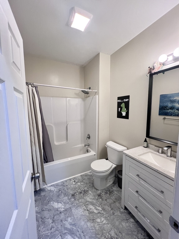 202 Broadway, Unit 33 Lawrence, MA 01840 - Photo 12 of 13 a bathroom with a sink toilet a mirror and shower
