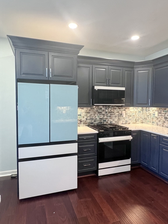 202 Broadway, Unit 33 Lawrence, MA 01840 - Photo 3 of 13 a kitchen with granite countertop white cabinets and stainless steel appliances