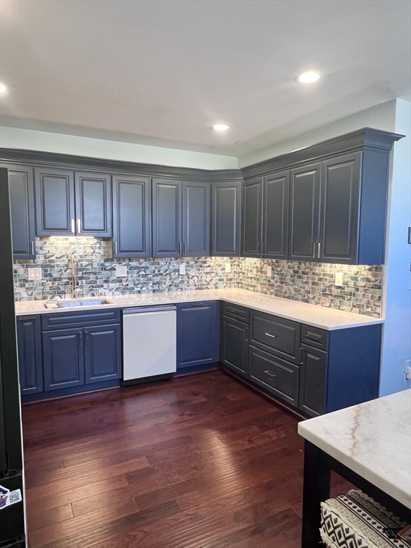202 Broadway, Unit 33 Lawrence, MA 01840 - Photo 4 of 13 a kitchen with granite countertop wooden cabinets and wooden floor
