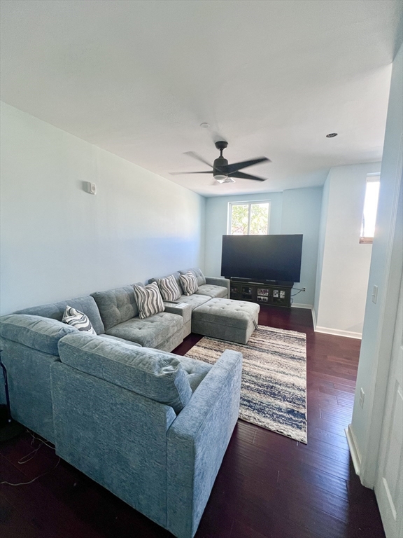 202 Broadway, Unit 33 Lawrence, MA 01840 - Photo 7 of 13 a living room with furniture and a wooden floor