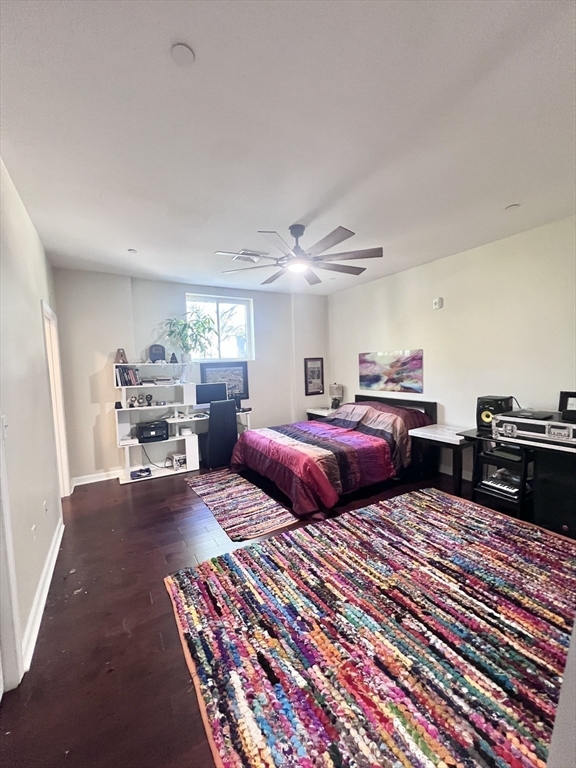 202 Broadway, Unit 33 Lawrence, MA 01840 - Photo 8 of 13 a bedroom with three beds and a couch