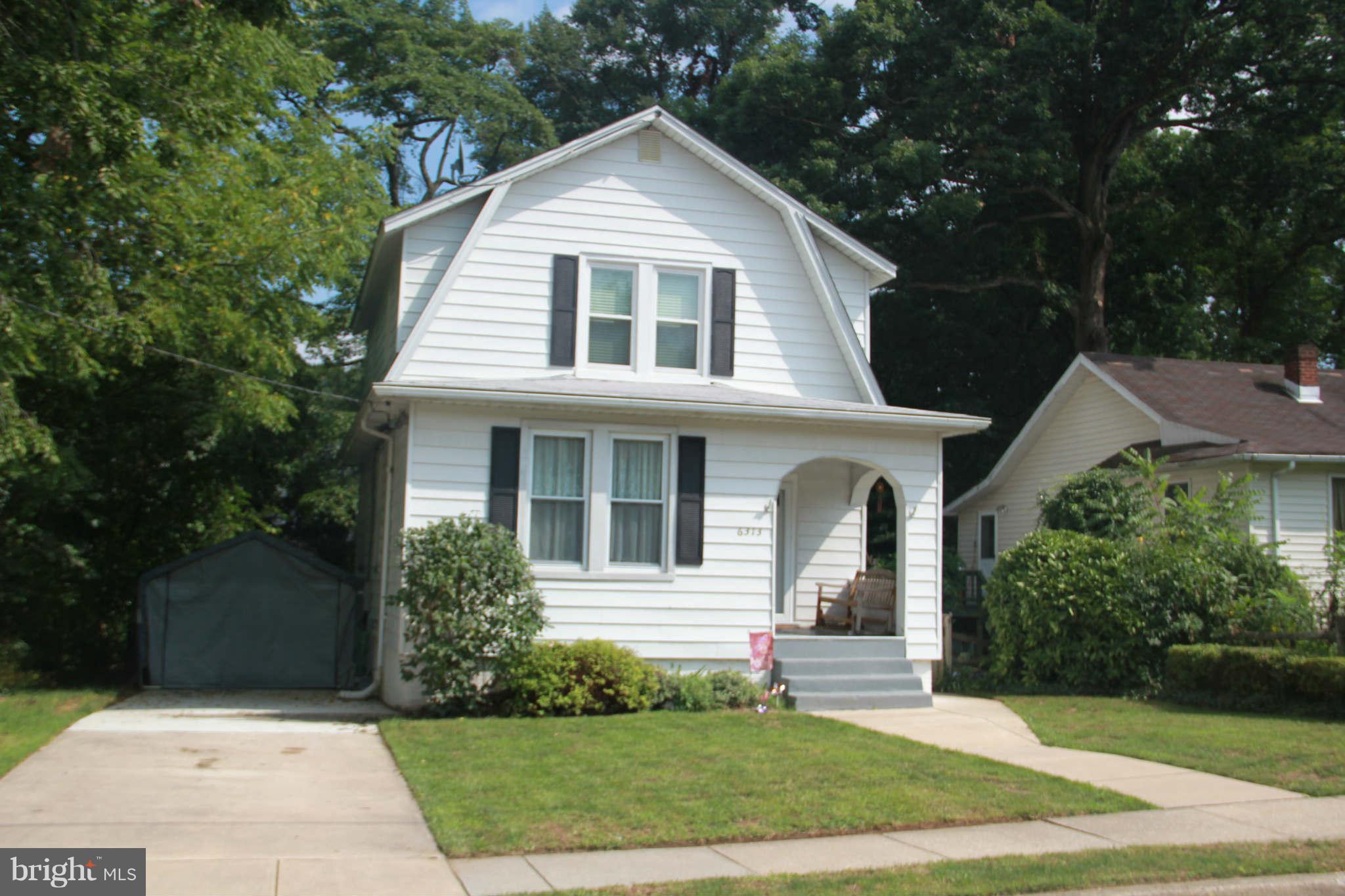 6313 Banbury Road Baltimore, MD 21239 - Photo 2 of 21 a front view of a house with a yard