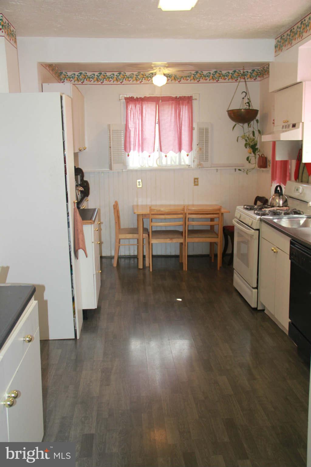 6313 Banbury Road Baltimore, MD 21239 - Photo 14 of 21 a kitchen with stainless steel appliances a stove a sink and a refrigerator