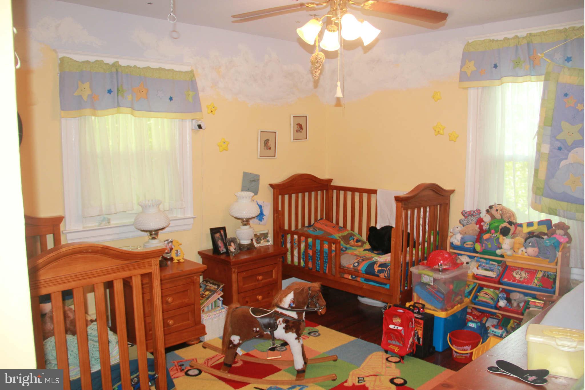 6313 Banbury Road Baltimore, MD 21239 - Photo 19 of 21 a bedroom with furniture a rug toys and a chandelier