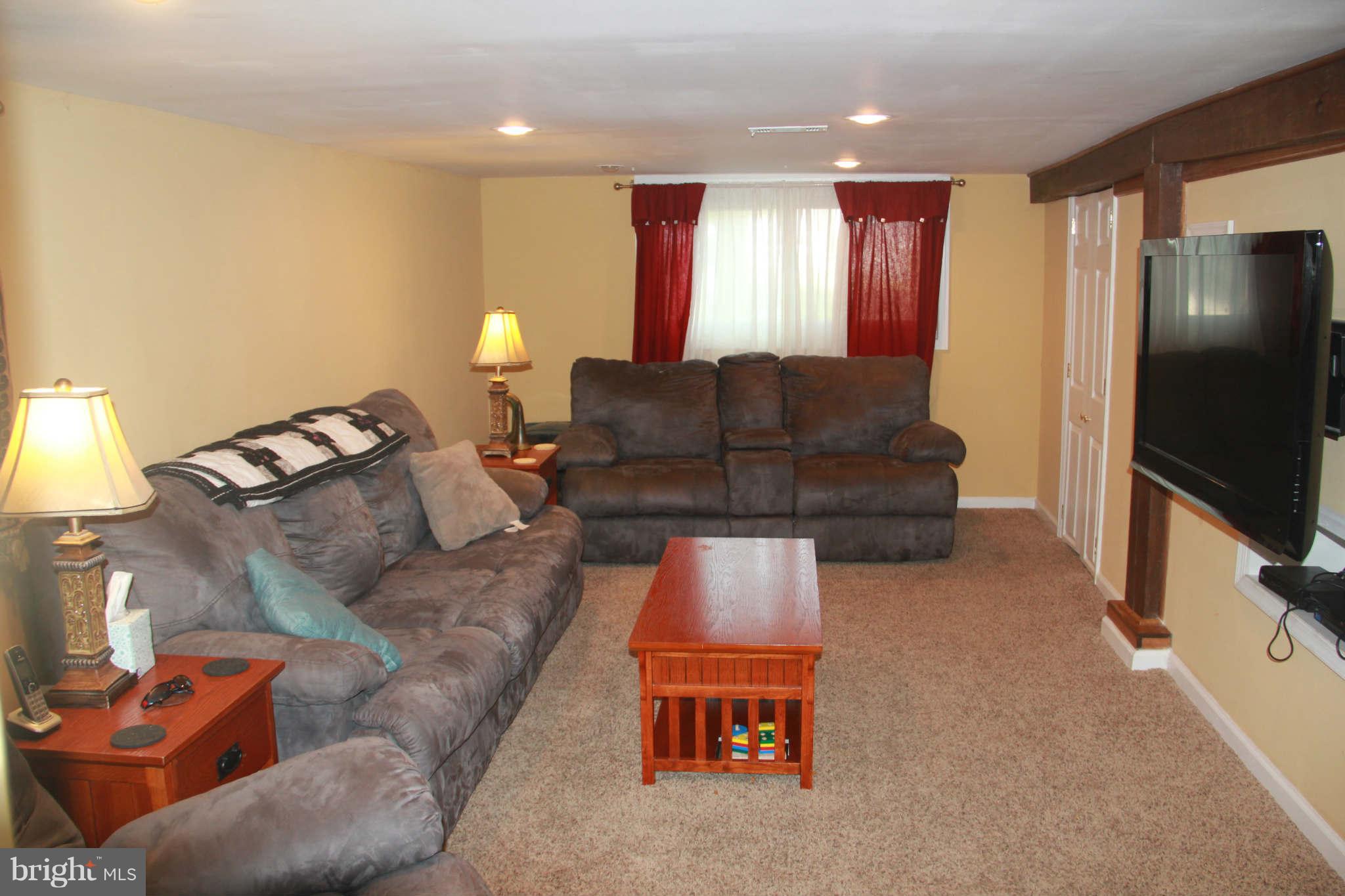 6313 Banbury Road Baltimore, MD 21239 - Photo 20 of 21 a living room with furniture and a flat screen tv