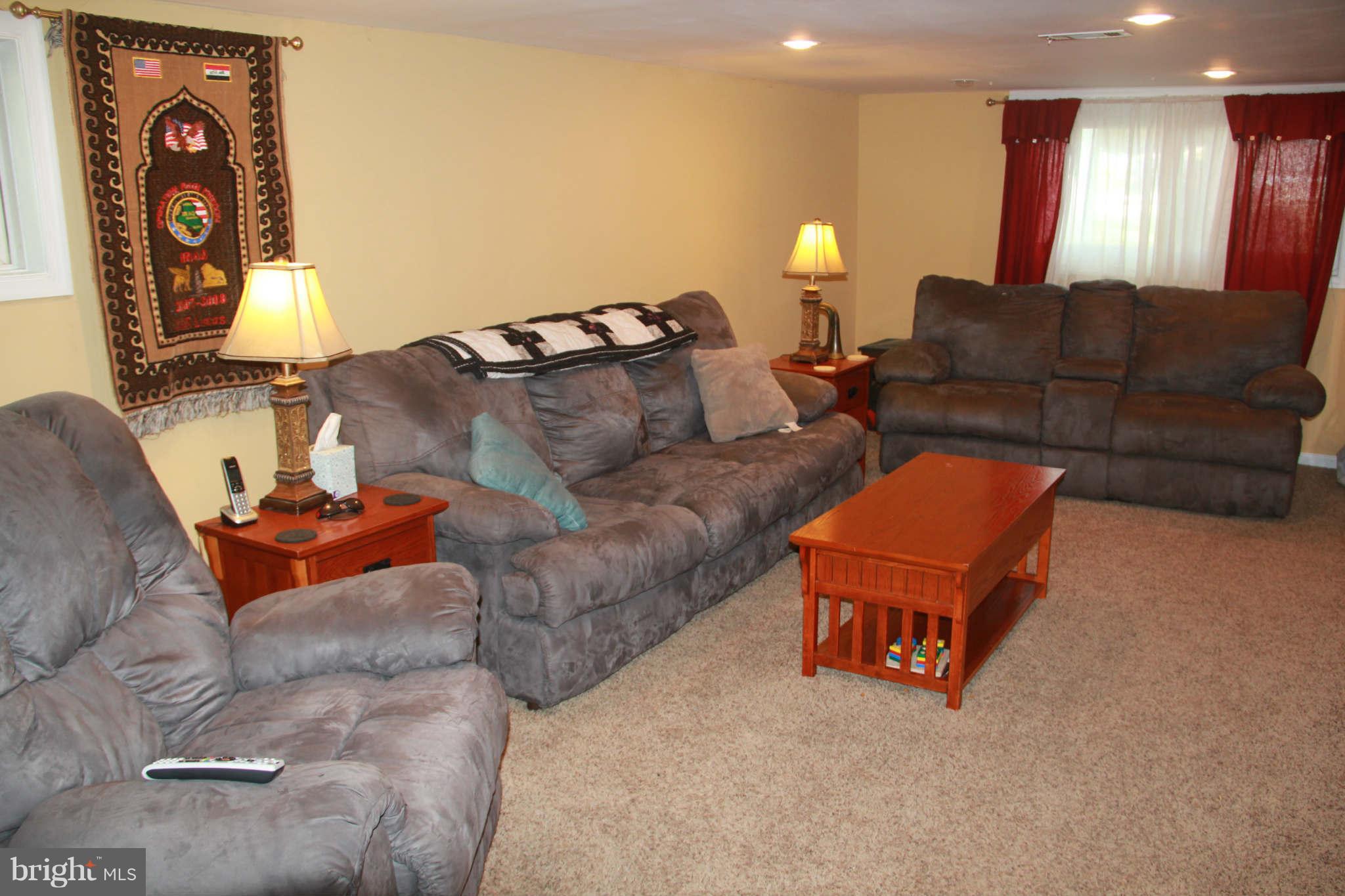 6313 Banbury Road Baltimore, MD 21239 - Photo 21 of 21 a living room with furniture and a lamp