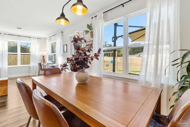a view of a dining room with furniture and chandelier