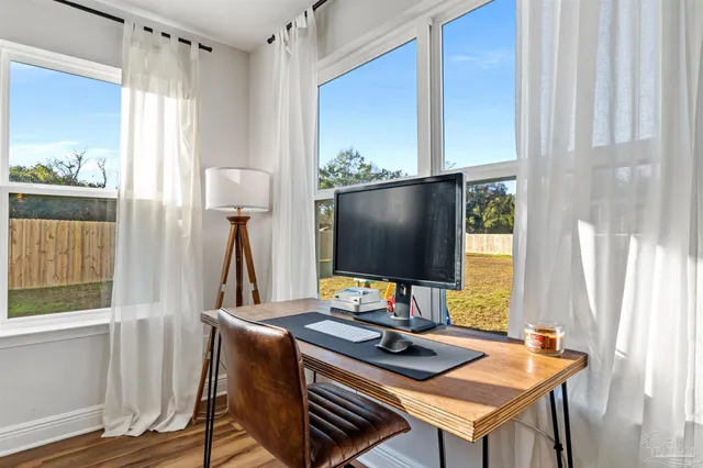 a desktop computer sitting on top of a desk next to a window