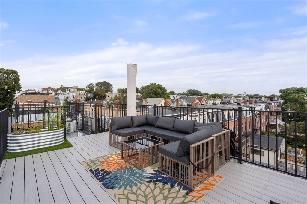 152 Marion Street, Unit 6L Boston, MA 02128 - Photo 17 of 22 a view of a balcony with wooden floor