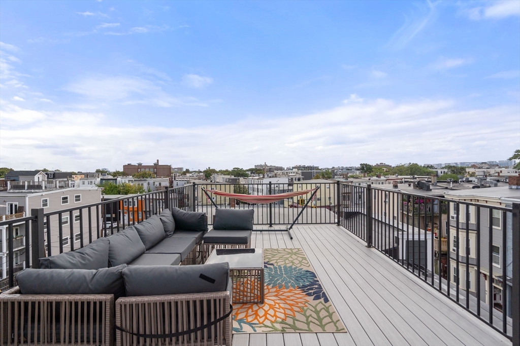 152 Marion Street, Unit 6L Boston, MA 02128 - Photo 18 of 22 a balcony with wooden floor and city view