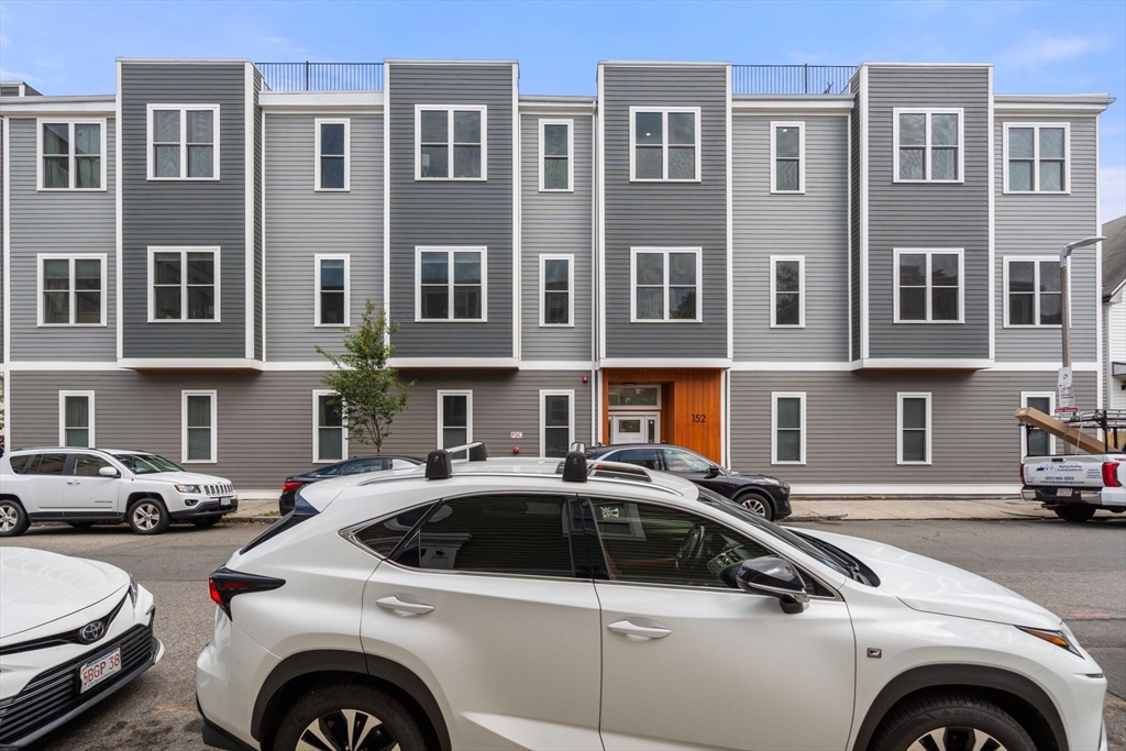 152 Marion Street, Unit 6L Boston, MA 02128 - Photo 21 of 22 a view of cars parked in front of a building