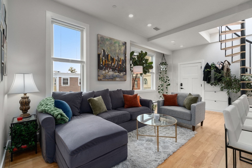 152 Marion Street, Unit 6L Boston, MA 02128 - Photo 6 of 22 a living room with furniture and a large window