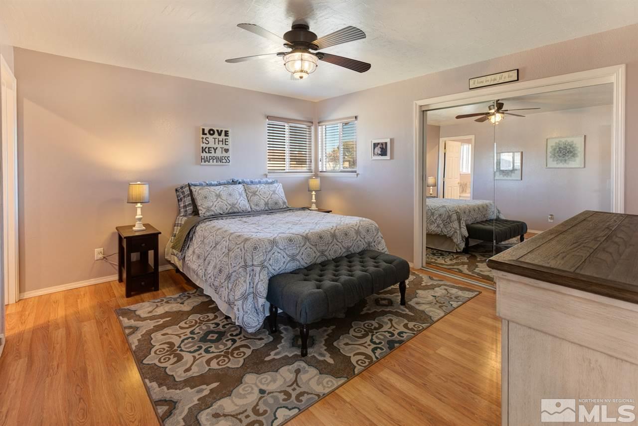 3120 Schindler Road Fallon, NV 89406 - Photo 13 of 21 a bed room with a bed and a chandelier