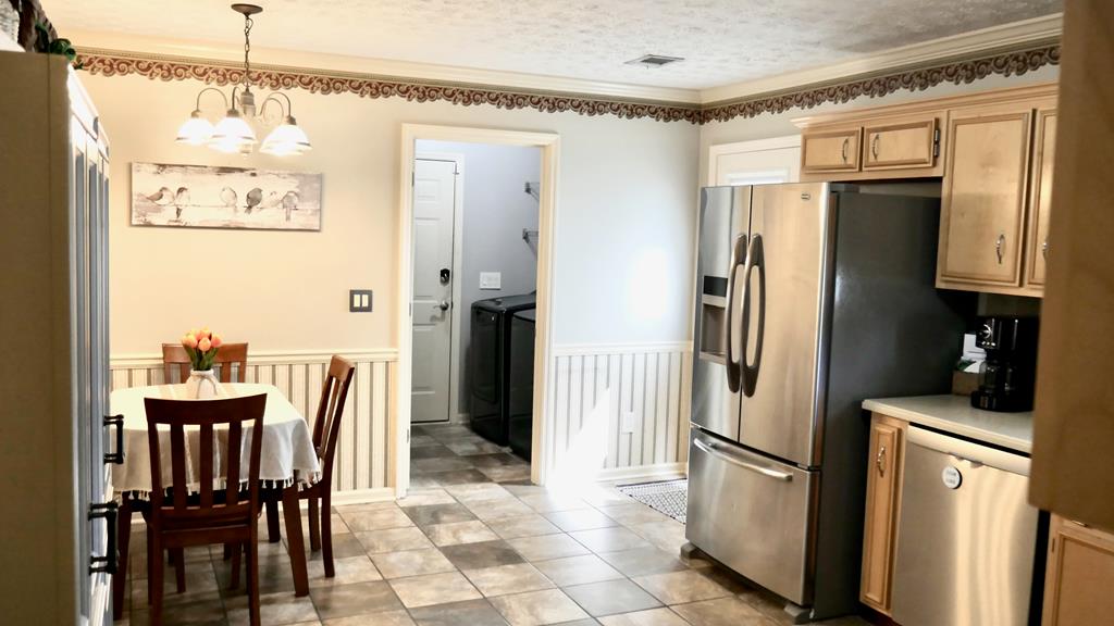 43 Chive Court Columbus, GA 31909 - Photo 13 of 37 a kitchen with refrigerator and table