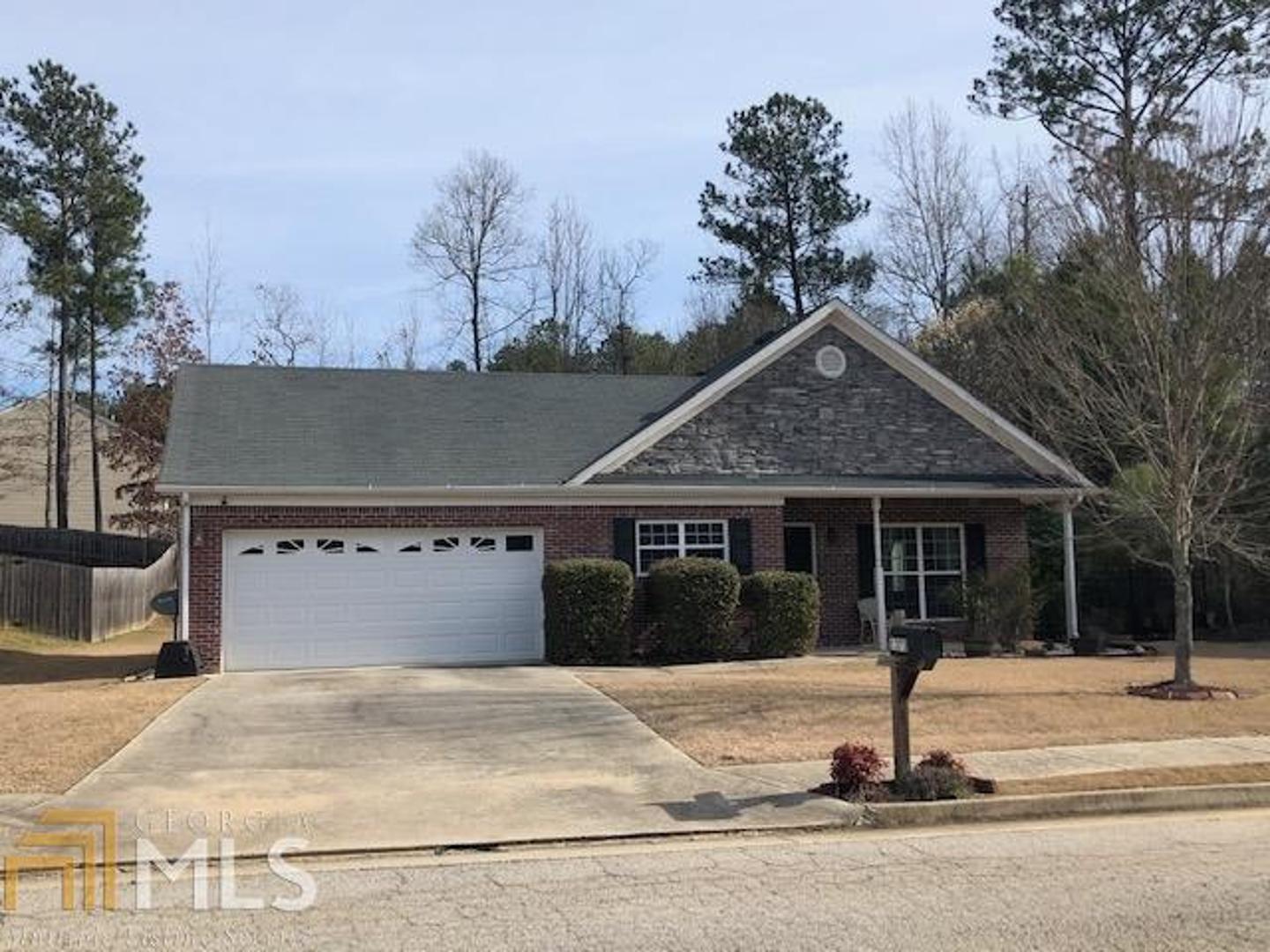 1373 Pebble Ridge Drive Hampton, GA 30228 - Photo 1 of 1 a front view of a house with a garden