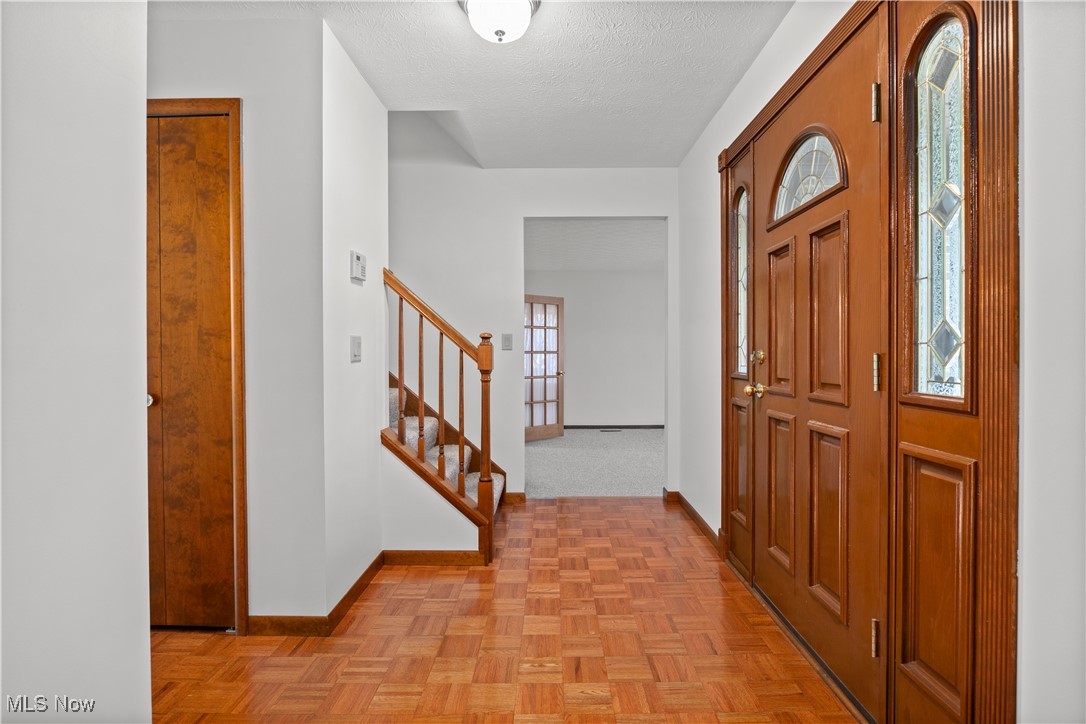 1711 Gulf Road Elyria, OH 44035 - Photo 24 of 50 Foyer entrance featuring stairway and a textured ceiling