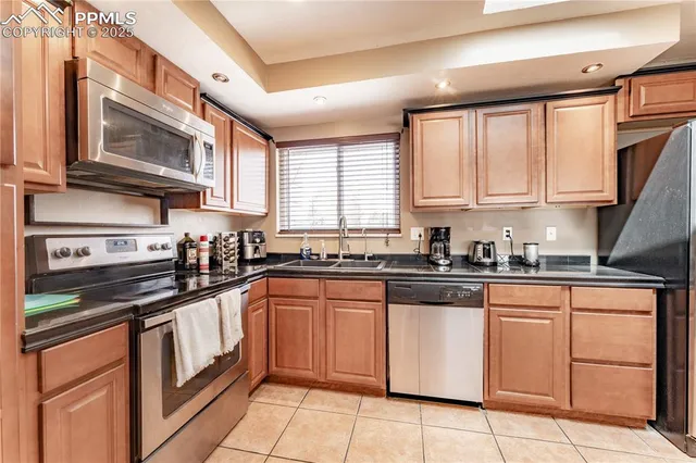 a kitchen with stainless steel appliances granite countertop a stove sink and cabinets