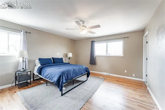 a bedroom with a bed and a ceiling fan