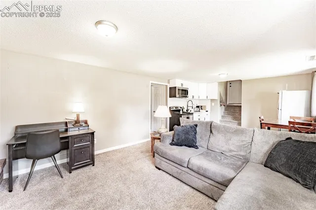 a view of a livingroom with furniture and a flat screen tv