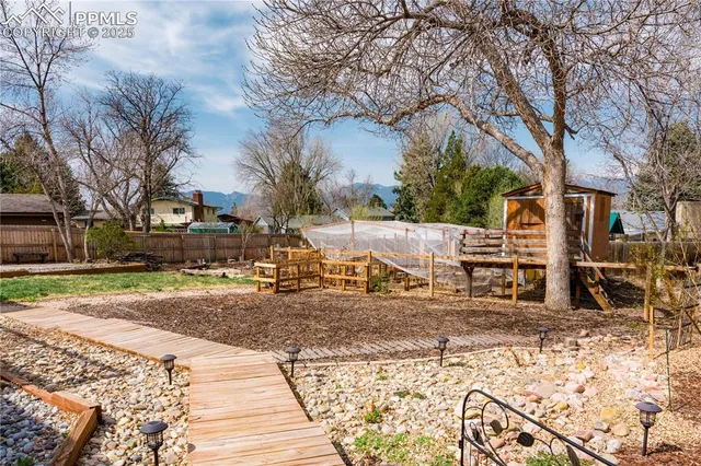 a view of a backyard with wooden fence