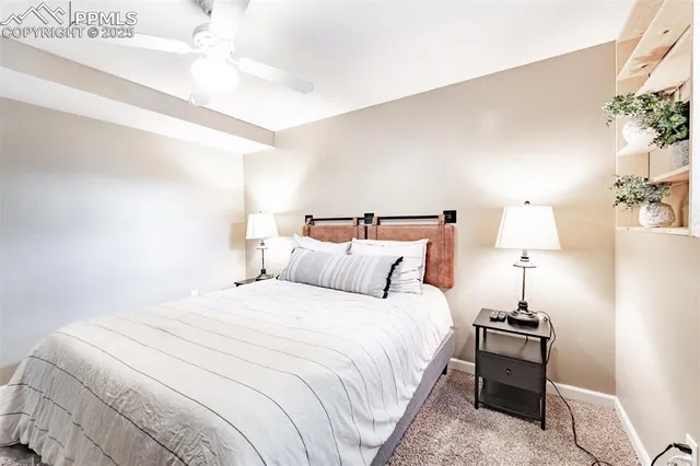 a bedroom with bed and a chandelier