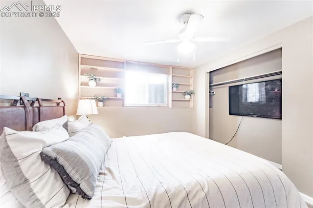 a bedroom with a bed and a mirror