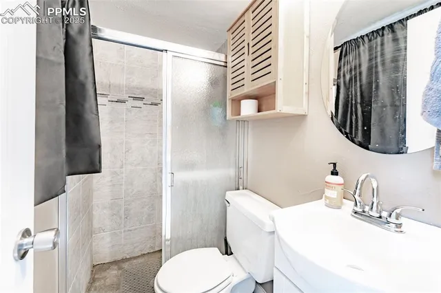 a bathroom with a toilet sink and shower
