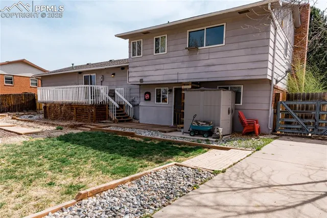 a view of a house with backyard and sitting area