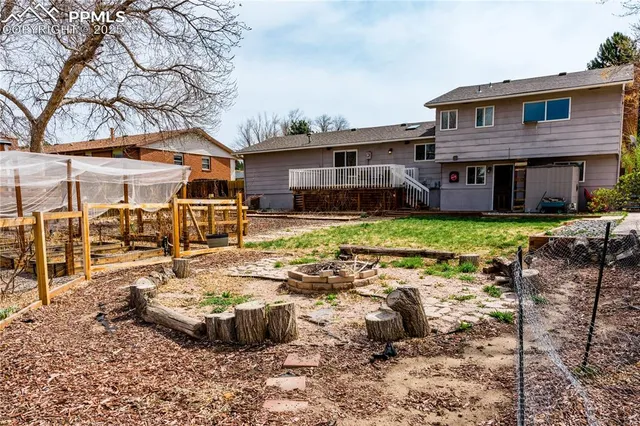 a view of a house with backyard and sitting area