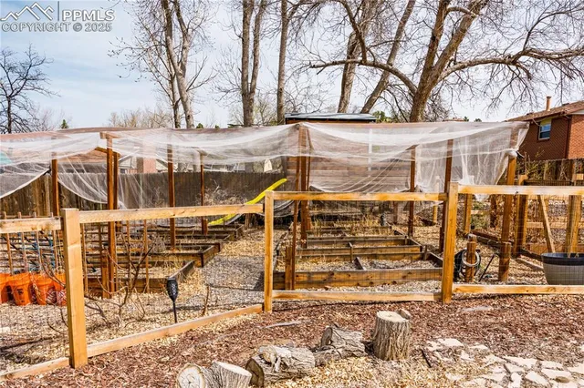 a view of a house with large trees