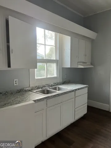 a kitchen with a sink and cabinets