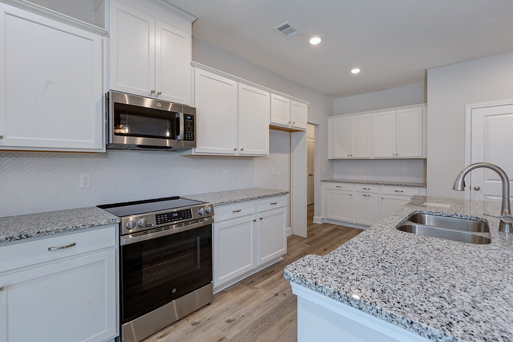 8711 McKee Road Upatoi, GA 31829 - Photo 13 of 45 a kitchen with appliances a sink and a stove