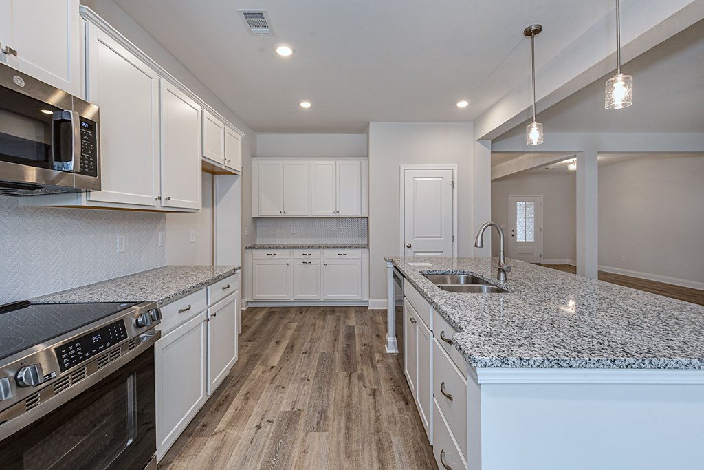 8711 McKee Road Upatoi, GA 31829 - Photo 14 of 45 a kitchen with stainless steel appliances granite countertop a sink stove and cabinets