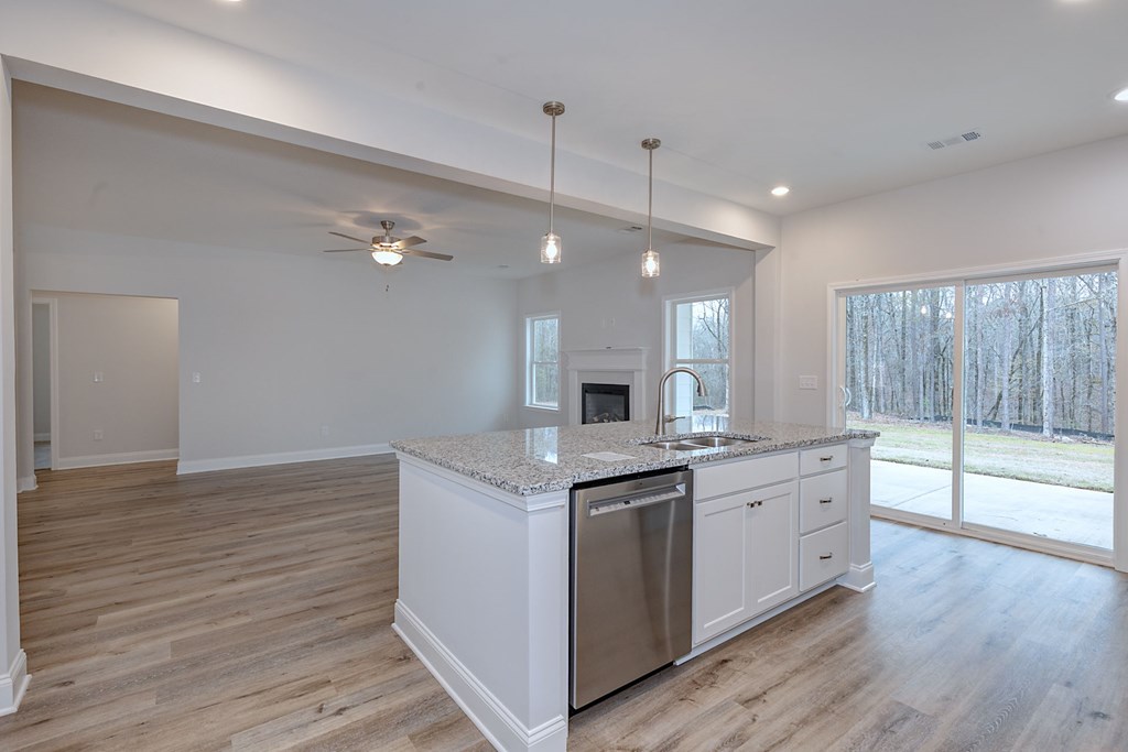 8711 McKee Road Upatoi, GA 31829 - Photo 18 of 45 a kitchen with a stove and wooden floor
