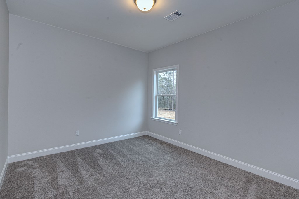 8711 McKee Road Upatoi, GA 31829 - Photo 19 of 45 an empty room with a window