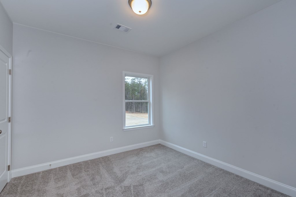 8711 McKee Road Upatoi, GA 31829 - Photo 21 of 45 an empty room with a window