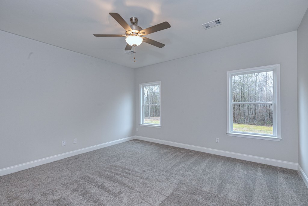 8711 McKee Road Upatoi, GA 31829 - Photo 26 of 45 an empty room with windows and fan