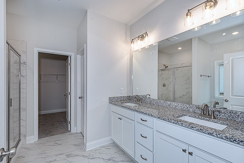 8711 McKee Road Upatoi, GA 31829 - Photo 27 of 45 a bathroom with a granite countertop sink and a mirror