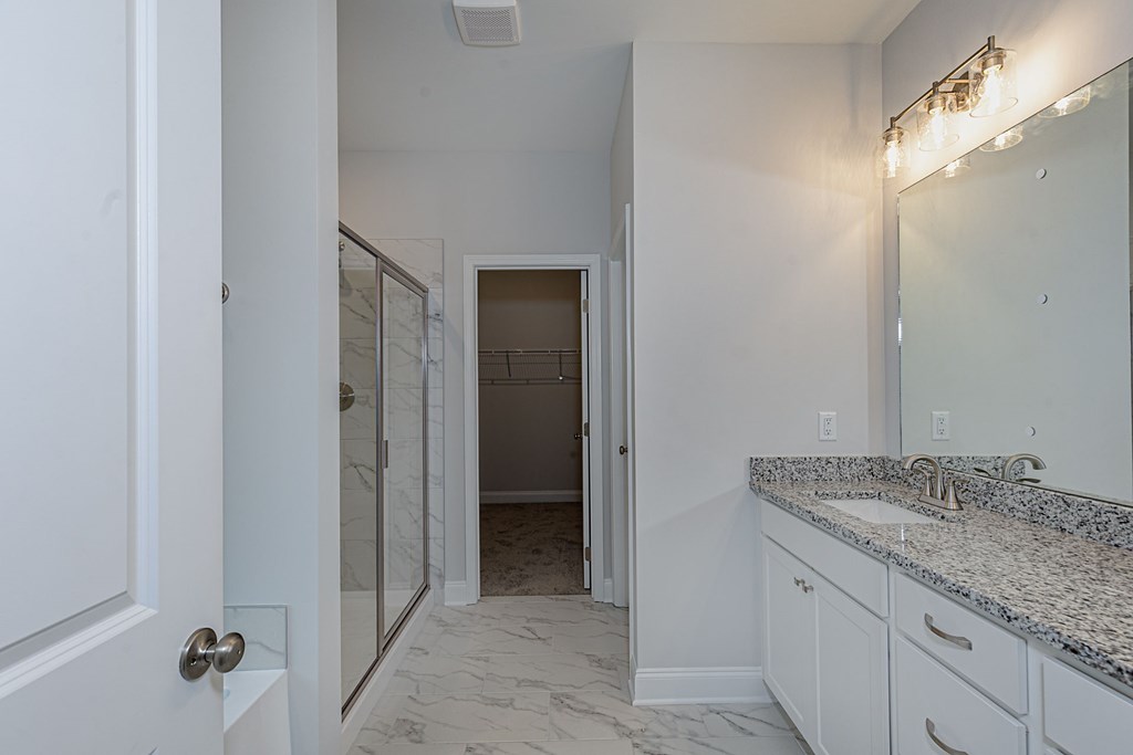 8711 McKee Road Upatoi, GA 31829 - Photo 29 of 45 a bathroom with a granite countertop sink and vanity