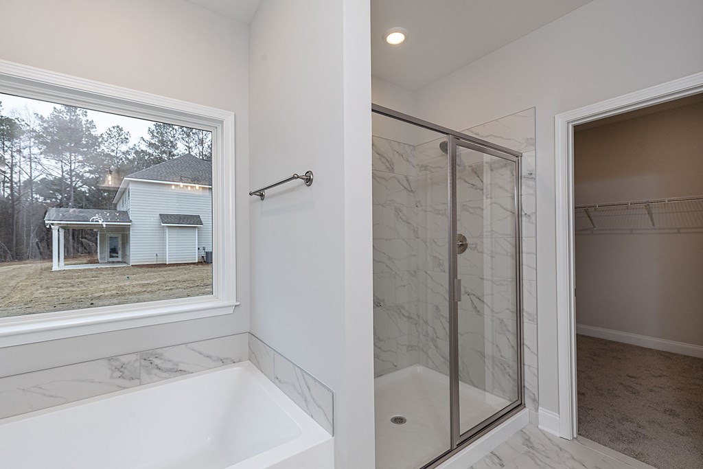 8711 McKee Road Upatoi, GA 31829 - Photo 30 of 45 a bathroom with a bathtub and a shower