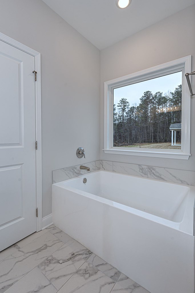 8711 McKee Road Upatoi, GA 31829 - Photo 34 of 45 a white bath tub sitting next to a window