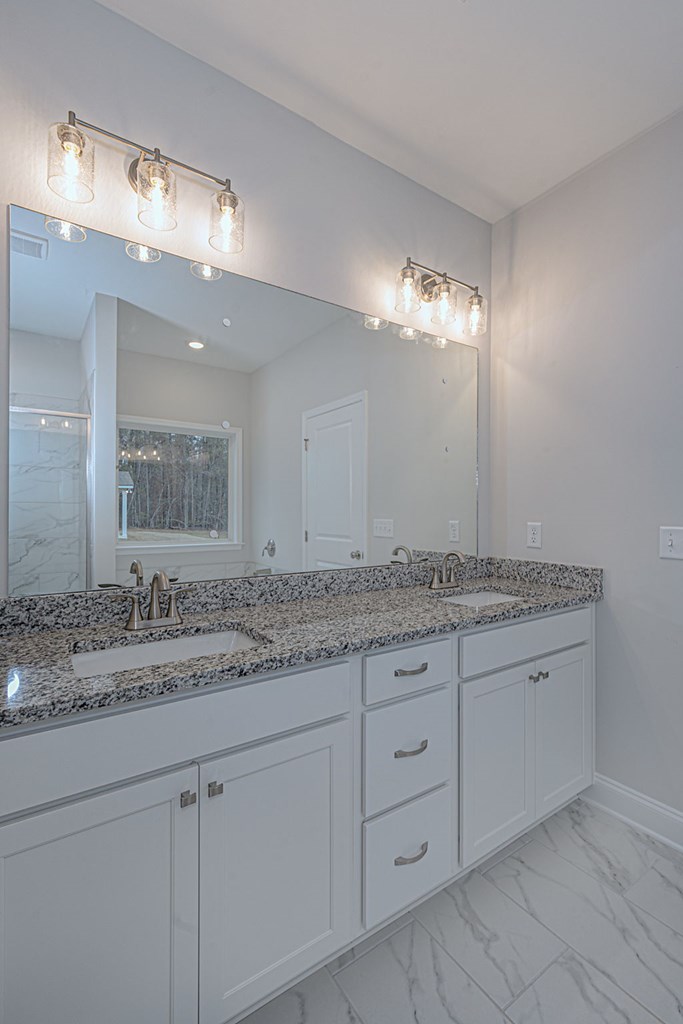 8711 McKee Road Upatoi, GA 31829 - Photo 35 of 45 a bathroom with a granite countertop double vanity sink and a mirror