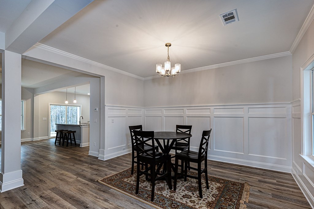 8711 McKee Road Upatoi, GA 31829 - Photo 4 of 45 a view of a dining room with furniture and wooden floor