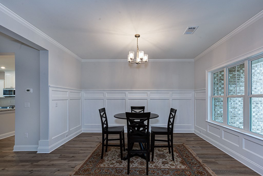 8711 McKee Road Upatoi, GA 31829 - Photo 5 of 45 a view of a dining room with furniture wooden floor and chandelier
