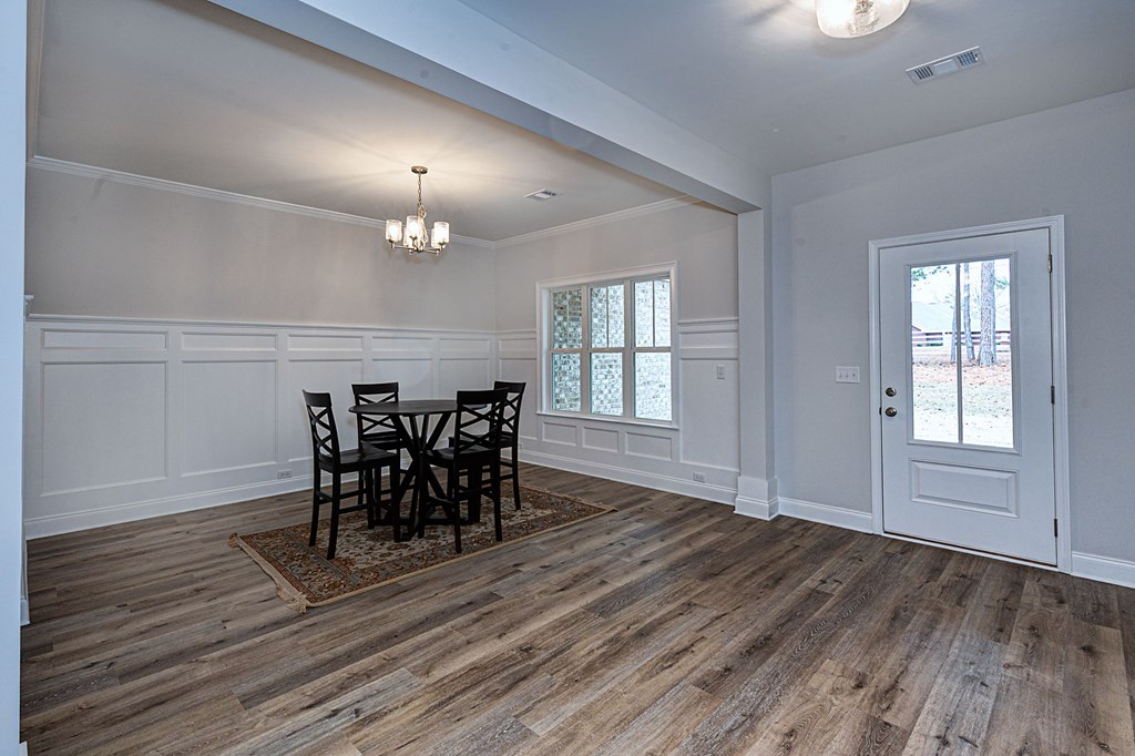 8711 McKee Road Upatoi, GA 31829 - Photo 6 of 45 a view of a dining room with furniture and wooden floor