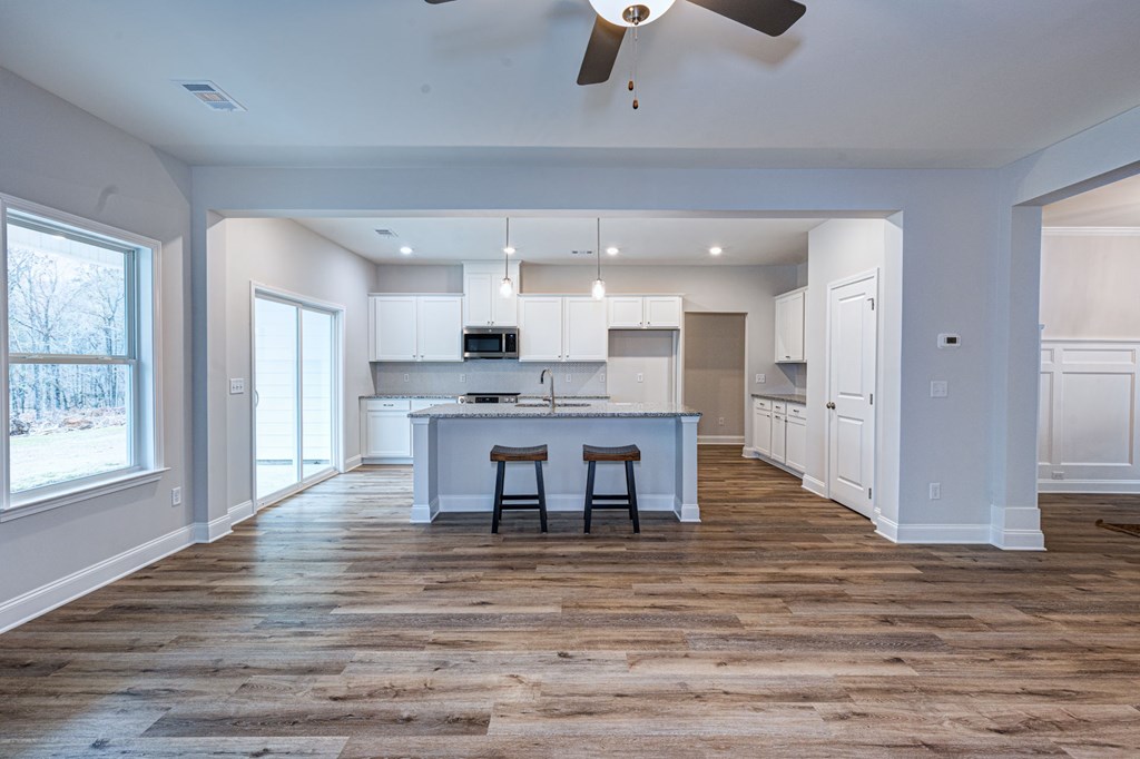 8711 McKee Road Upatoi, GA 31829 - Photo 8 of 45 a view of kitchen with kitchen island wooden floor center island and stainless steel appliances